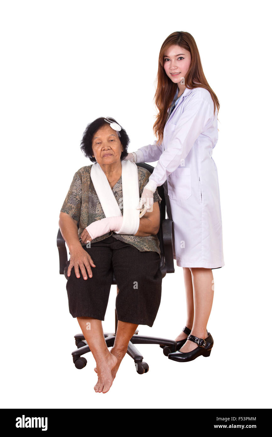 female doctor with senior woman injured on white background Stock Photo