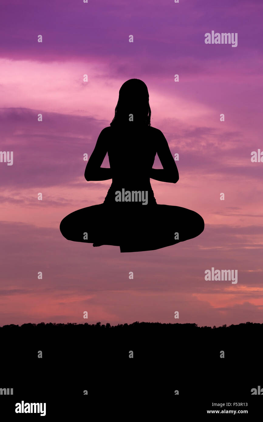 Silhouette of a beautiful Yoga woman at sunset Stock Photo - Alamy