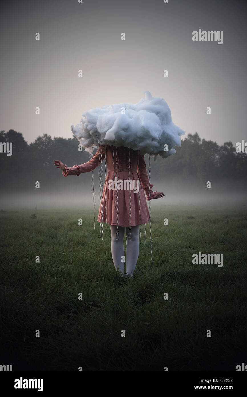 Woman with a cloud in rainy weather, surreal Stock Photo