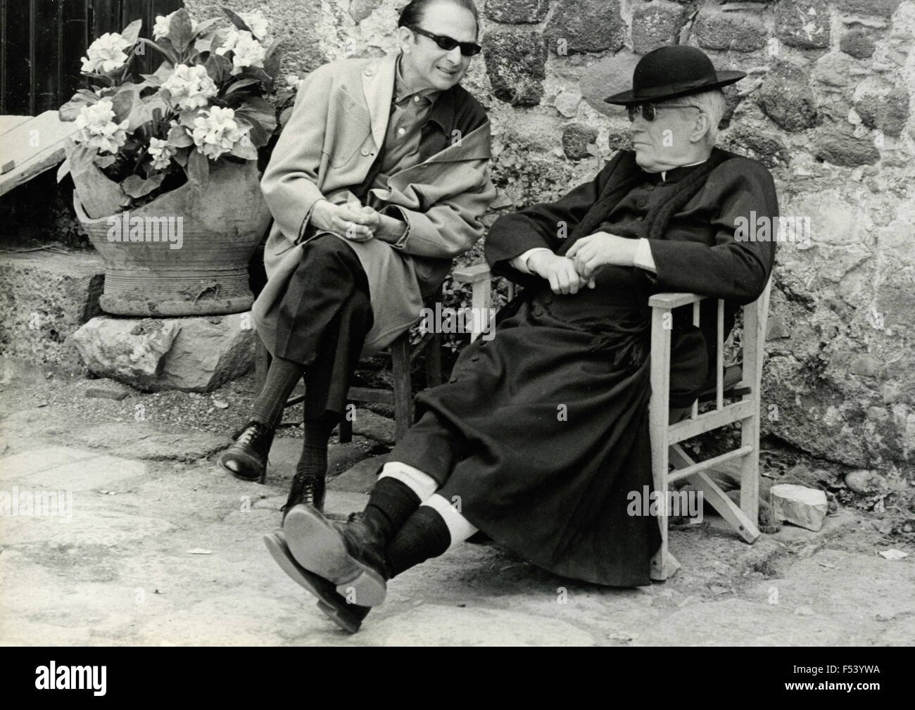 The French actor Maurice Chevalier dressed as a priest Stock Photo