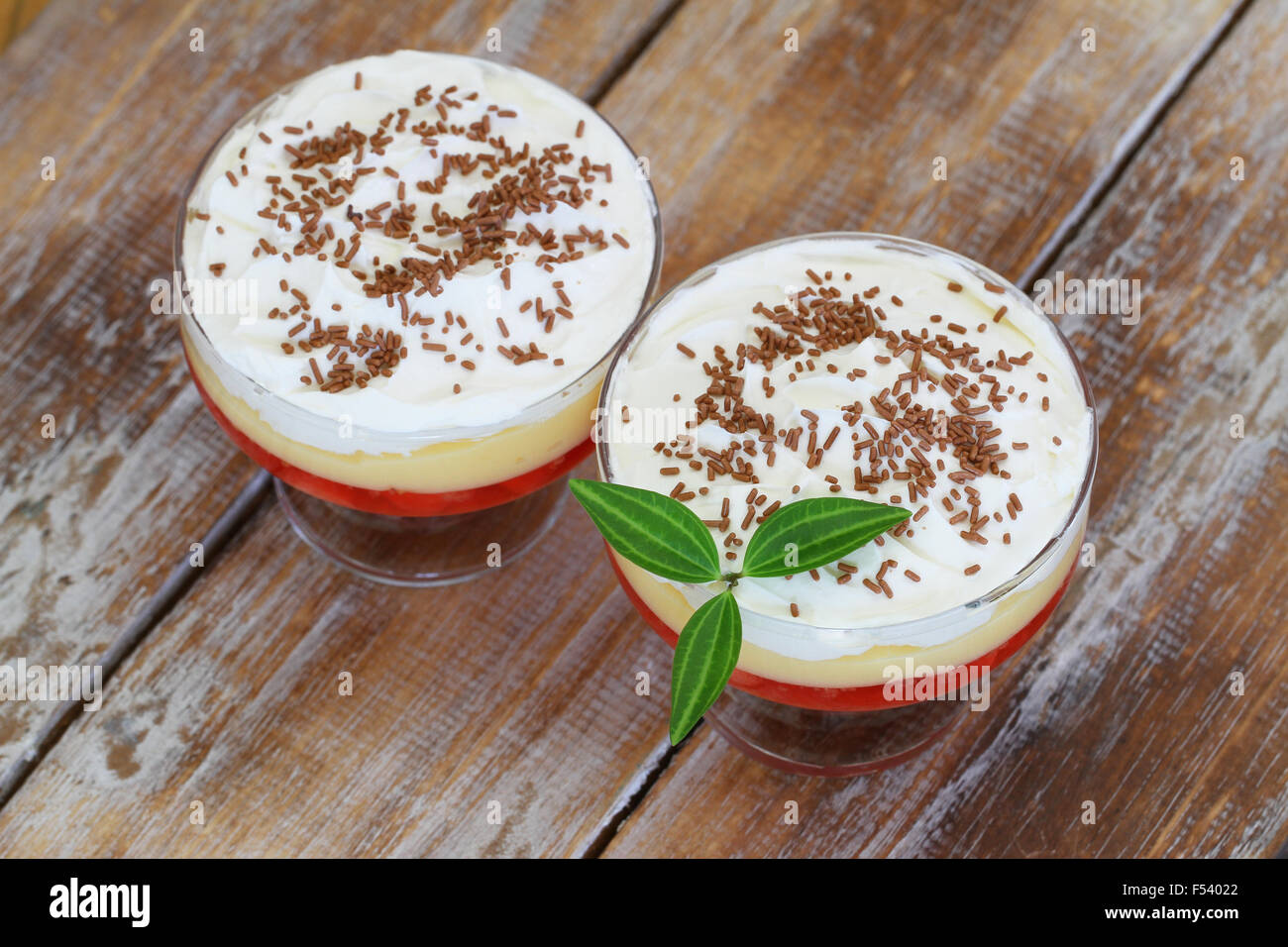 Traditional English trifle dessert on rustic wooden surface Stock Photo