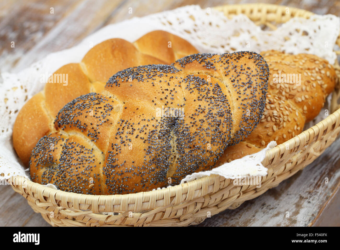 Challah bread with poppy seeds, sesame seeds and plain in bread basket Stock Photo Alamy