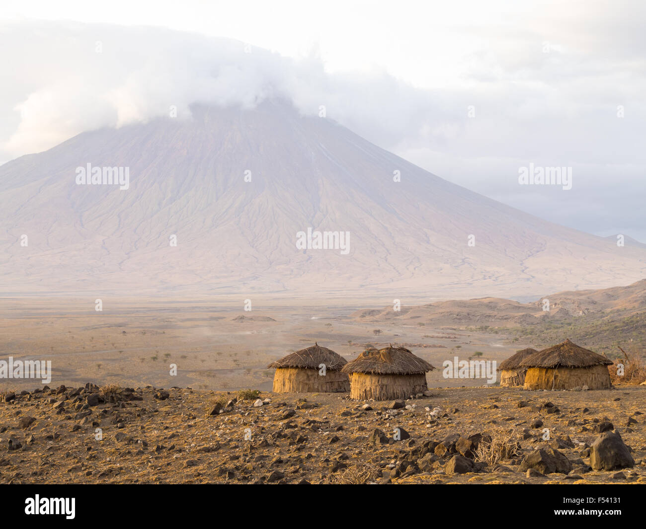 Maasai village in front of the Ol Doinyo Lengai in Arusha Region, Tanzania, Africa. Stock Photo