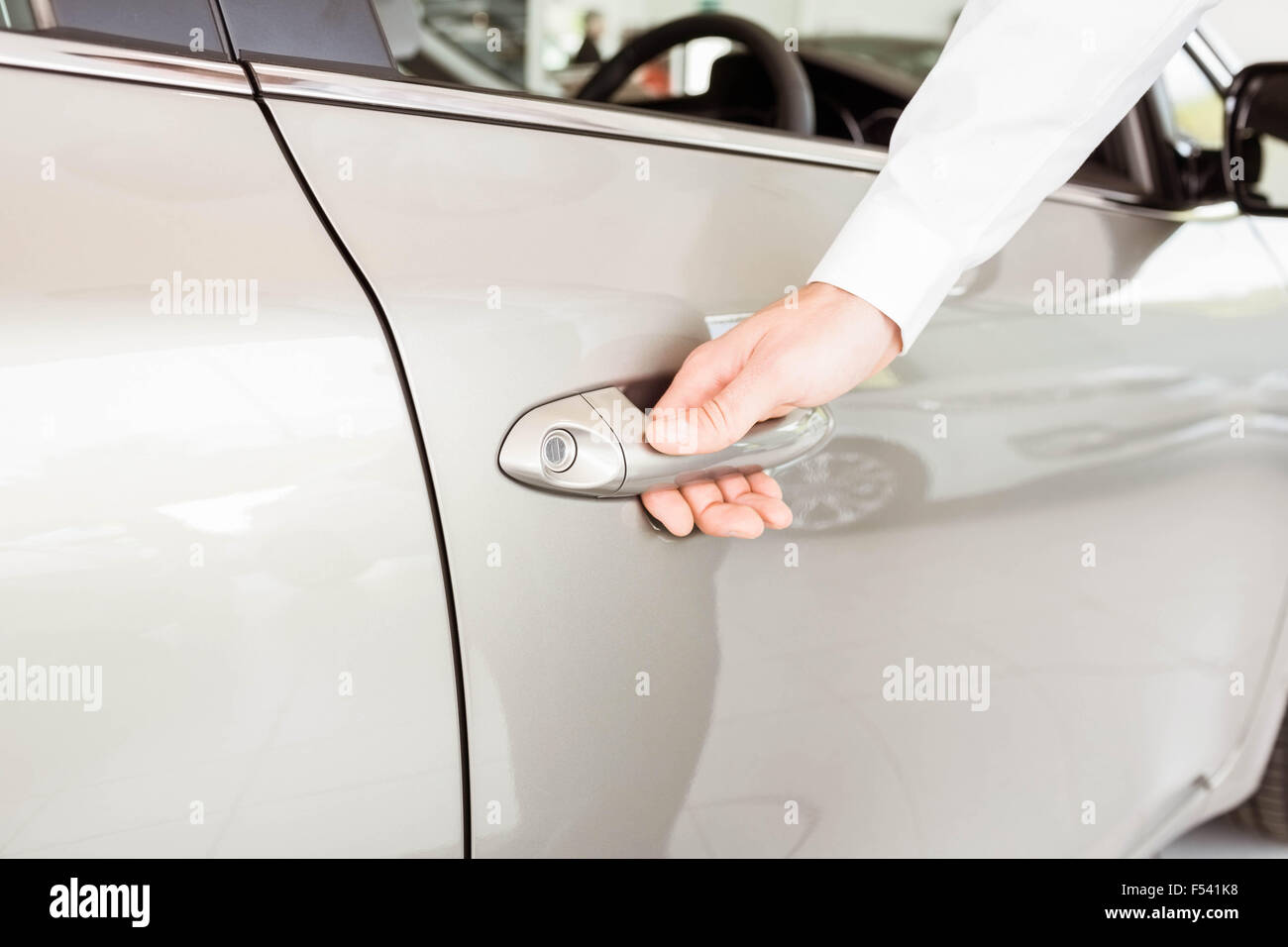 Man holding a car door handles Stock Photo