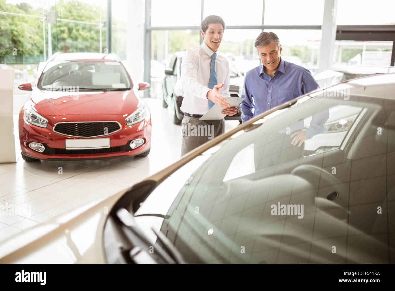 Salesman showing somethings to a man Stock Photo