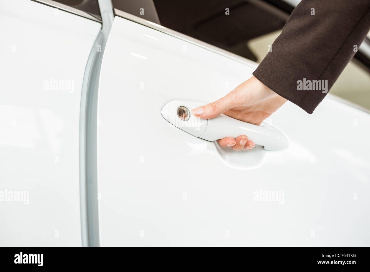 Saleswoman holding a car handles Stock Photo