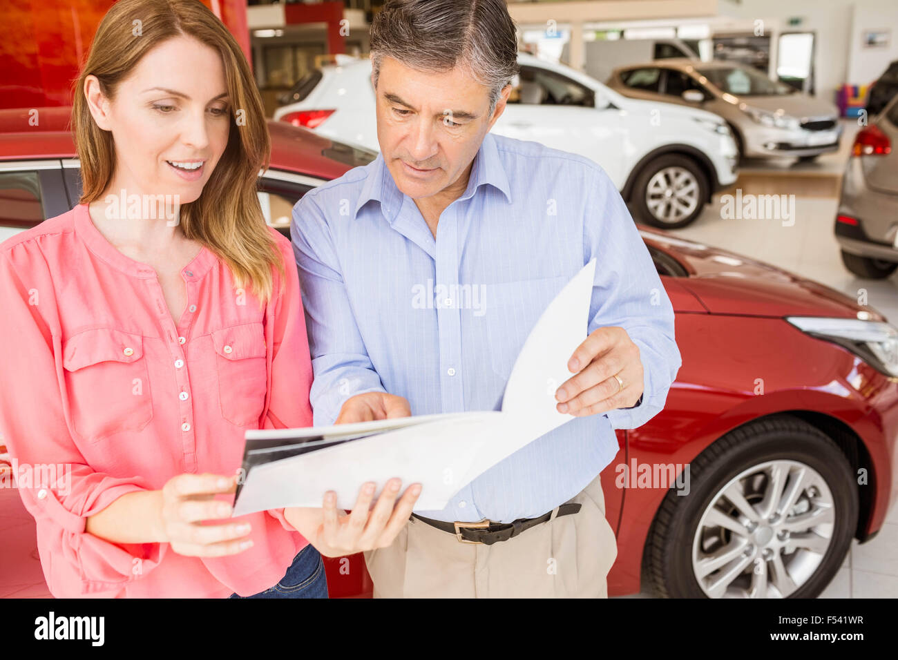 Smiling couple choosing the color of their new car Stock Photo