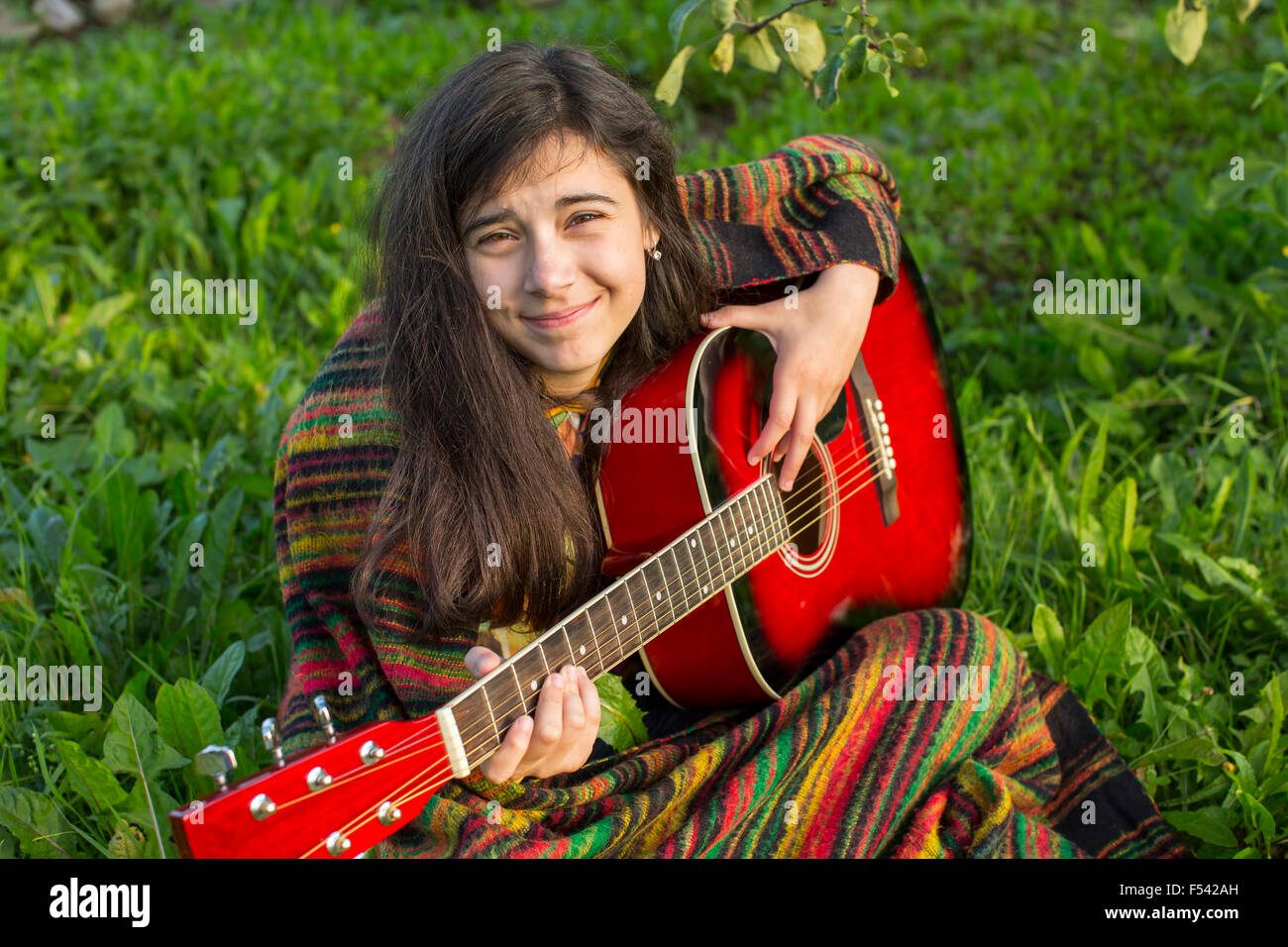 Teenage girl with an acoustic guitar outdoors Stock Photo - Alamy
