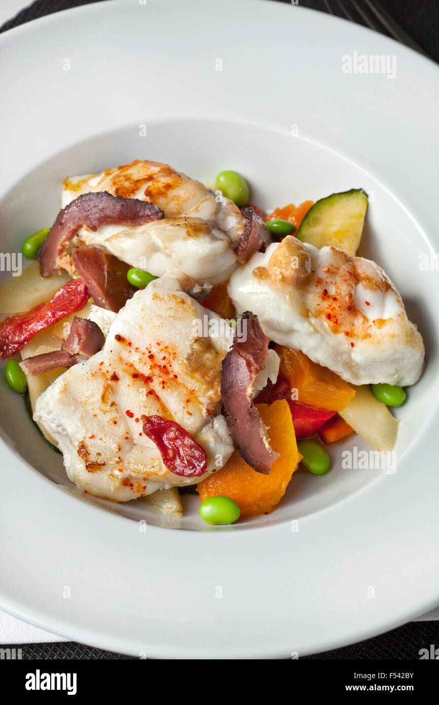 Monk fish, duck ham and vegetable on a plate Stock Photo