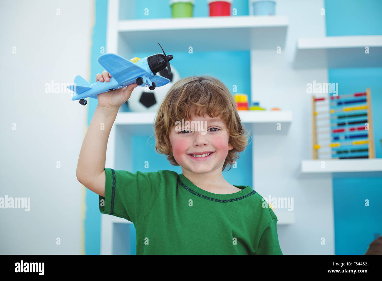 Small boy playing with a toy plane Stock Photo - Alamy