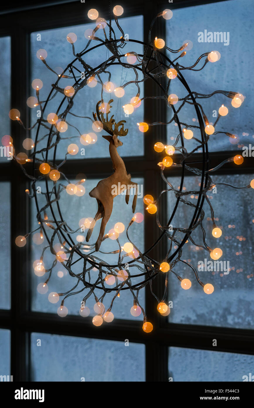 Christmas lights hanging on window indoors, Iceland Stock Photo
