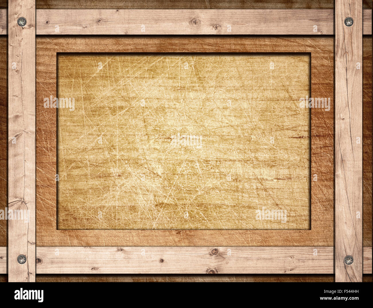 Brown frame screwed on wooden board Stock Photo