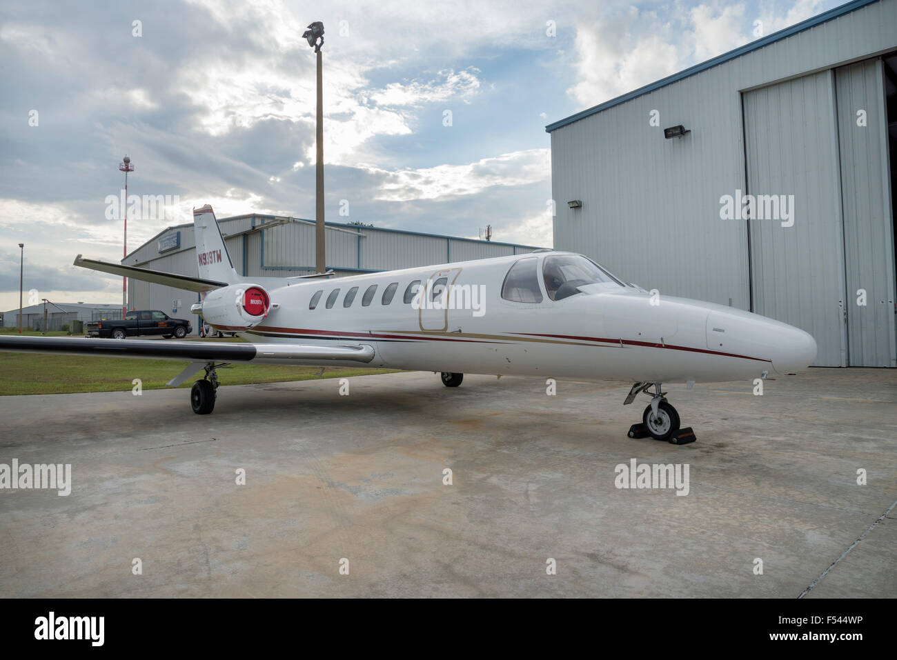 A small jet aircraft parked at a local general aviation air service