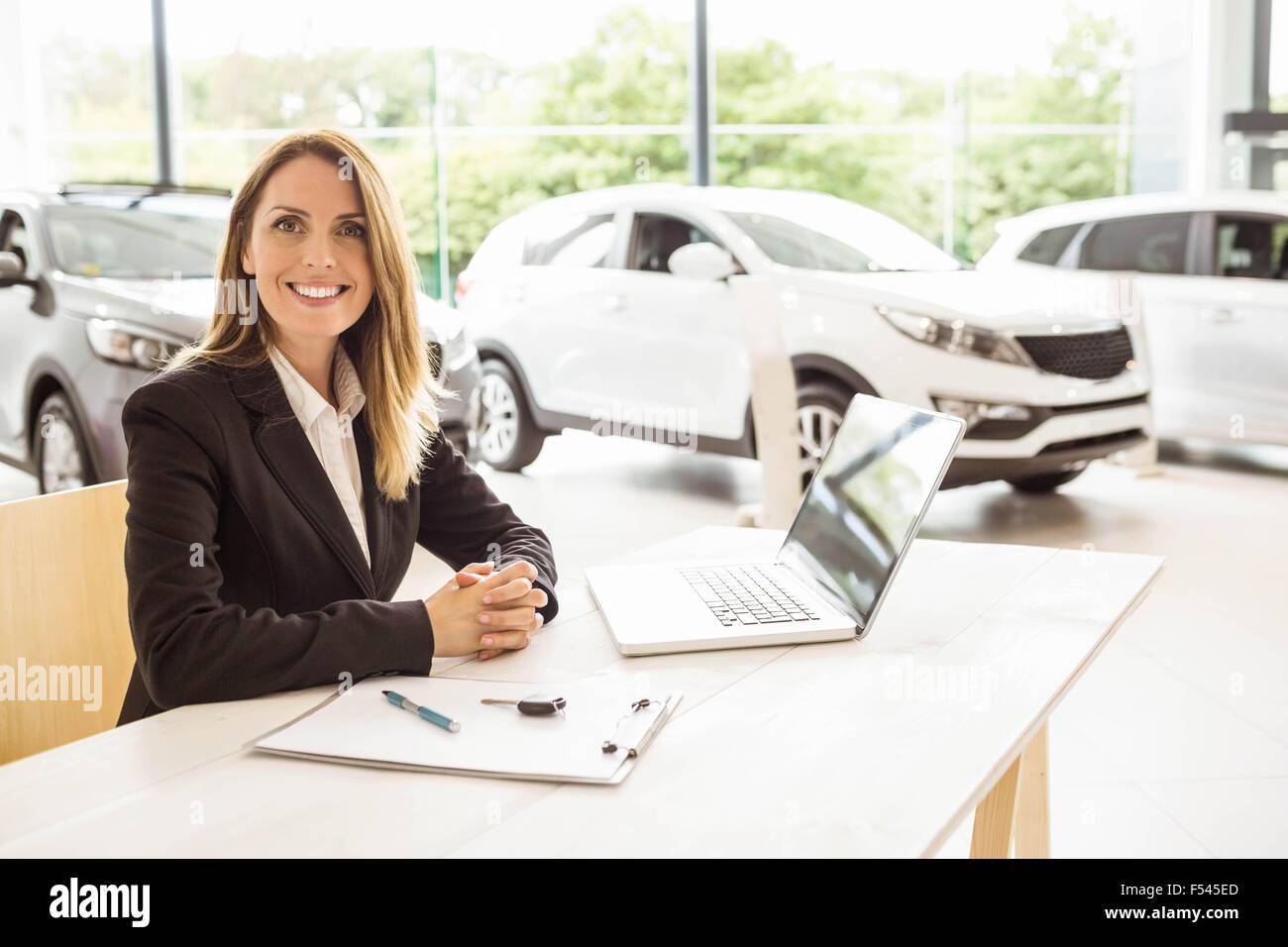 Happy businesswoman working at her desk Stock Photo - Alamy