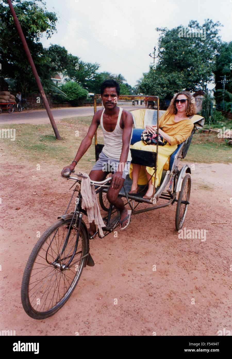 Young woman riding in bicycle taxi in Delhi India 1992 Stock Photo