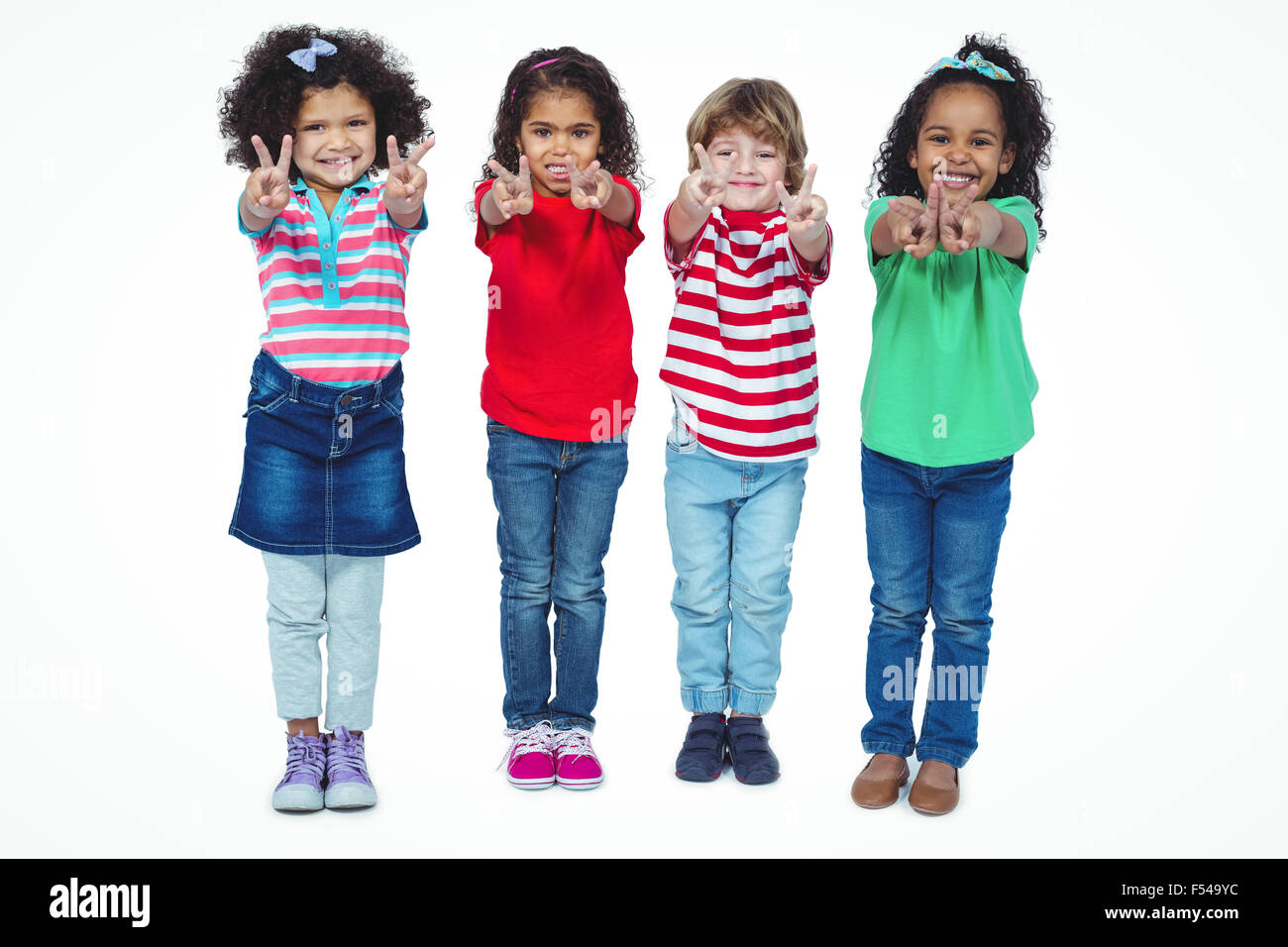 Smiling kids holding up fingers making peace signs Stock Photo Alamy