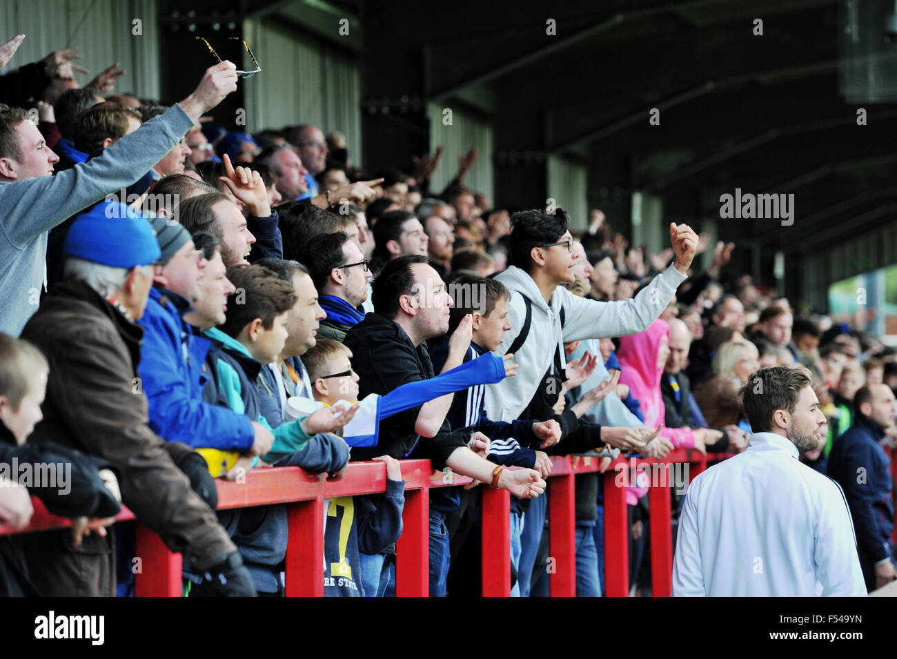Football fans jeering and making gestures at a referees decision during football match Stock Photo