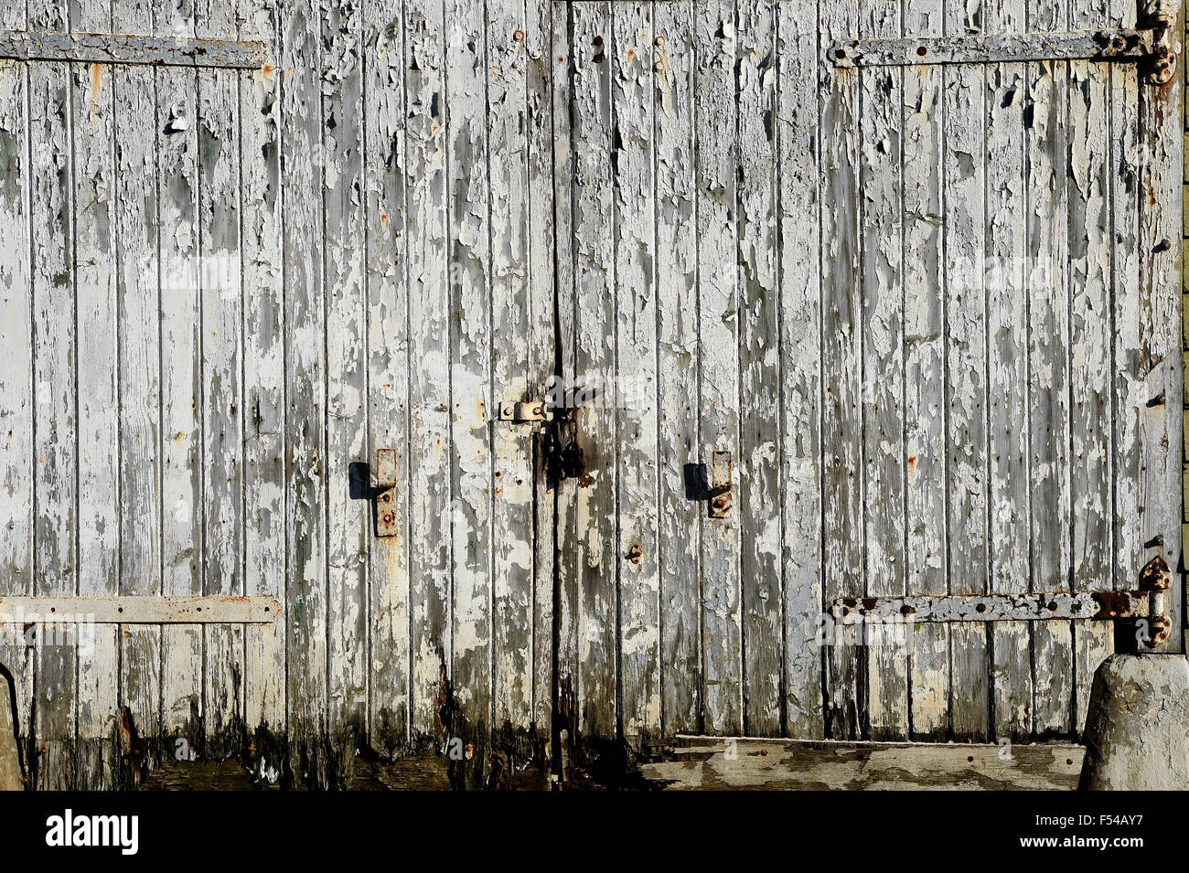 Paint peeling and flaking off an old barn building in Stanmer village Brighton Stock Photo