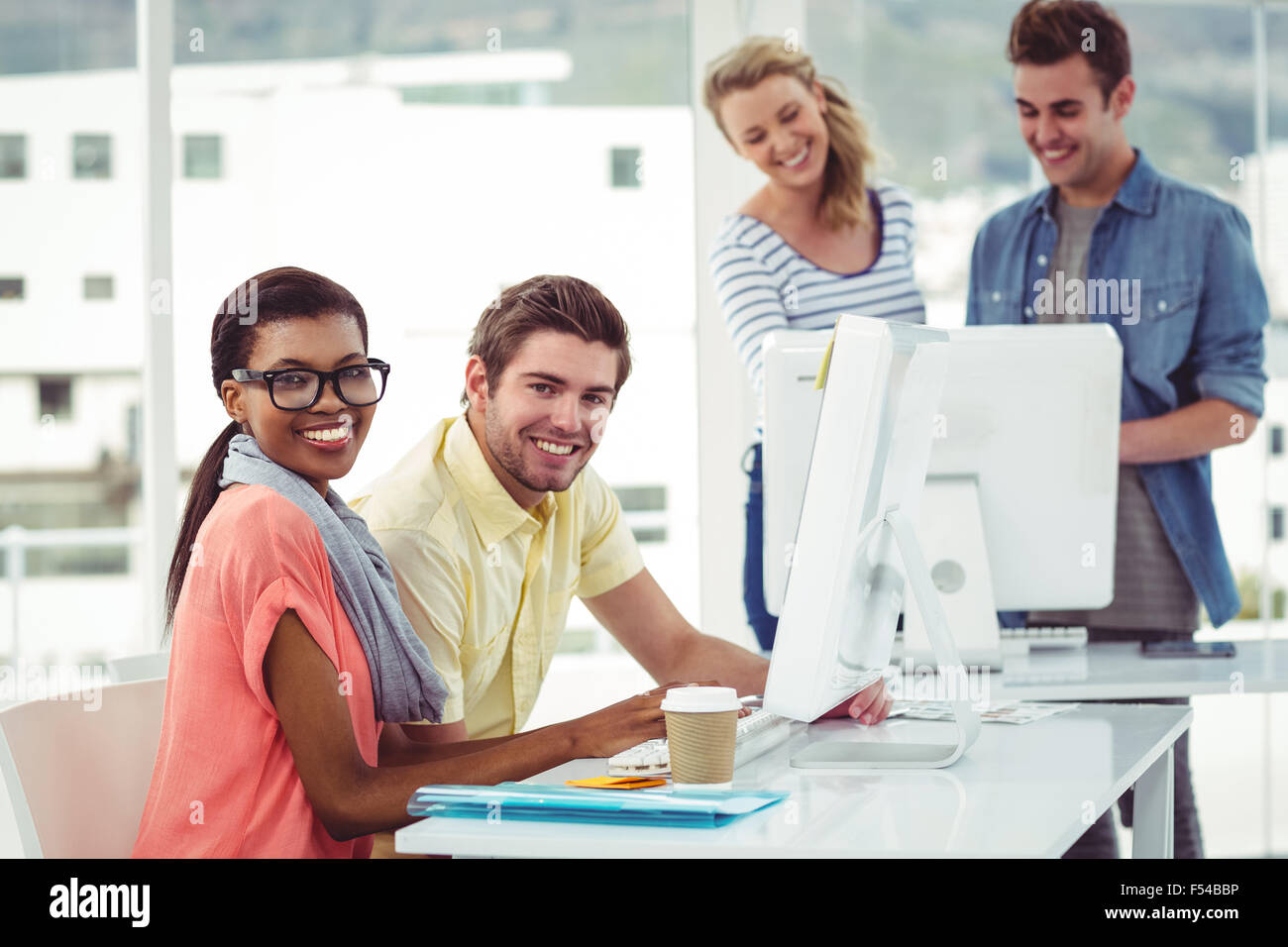 Creative business team working hard together on pc Stock Photo - Alamy