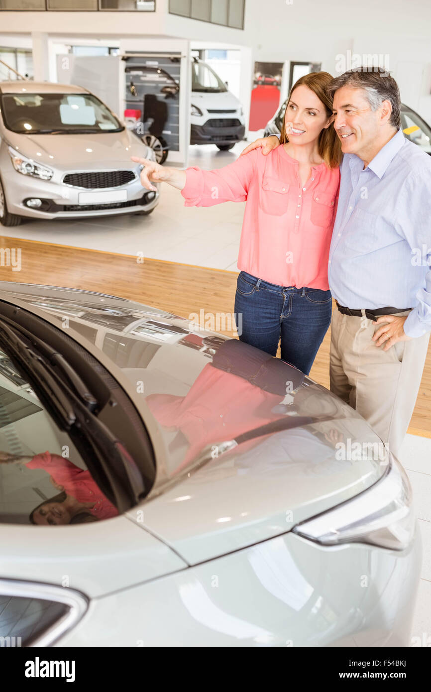 Couple talking together while looking at car Stock Photo