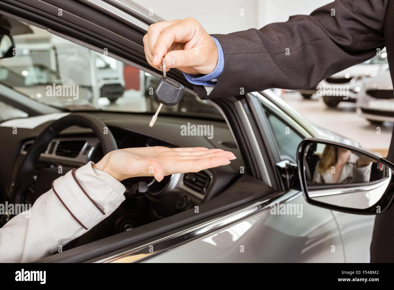 Salesman offering car key to a customers Stock Photo Alamy