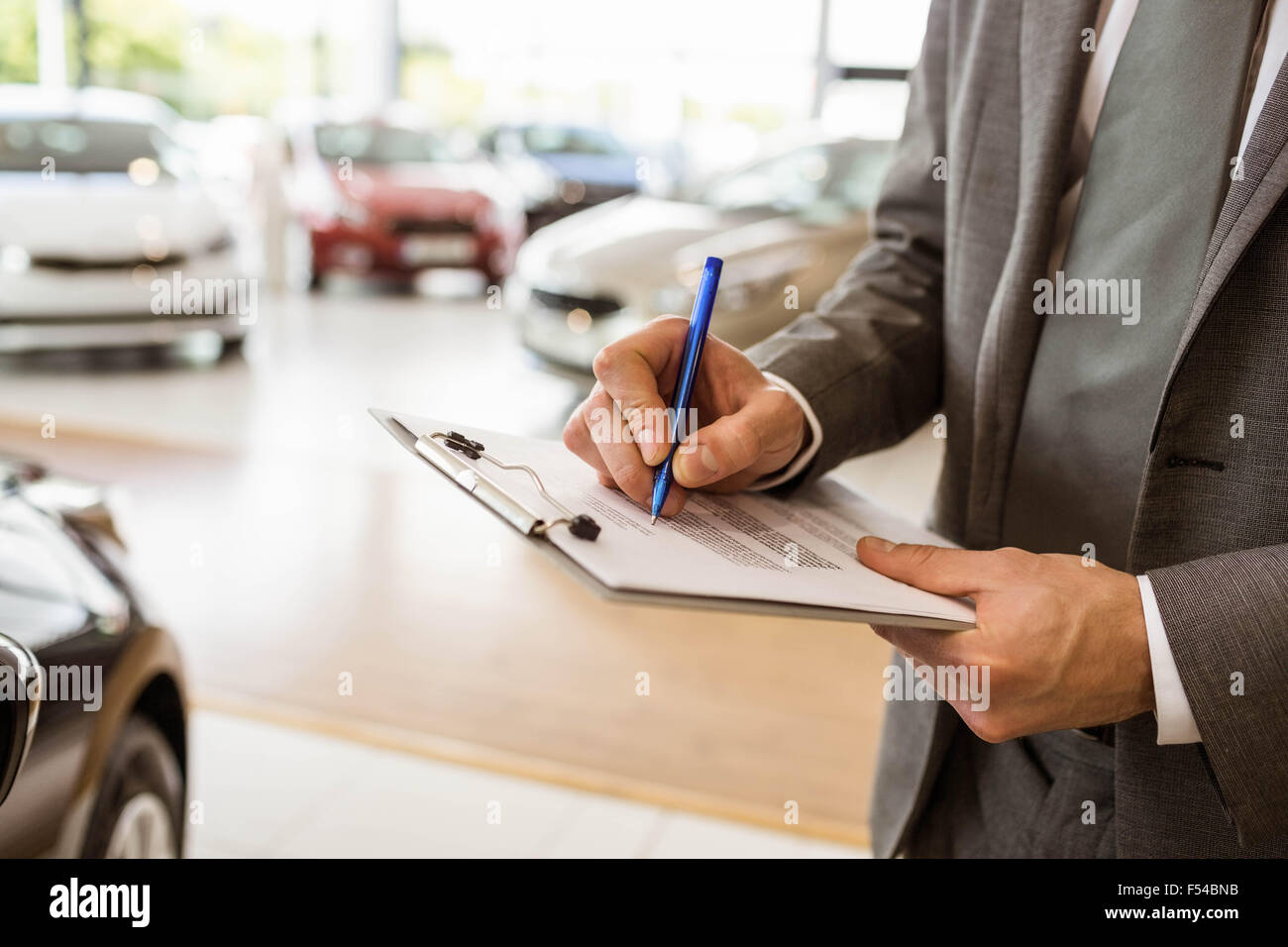 Focused businessman looking at the car body Stock Photo