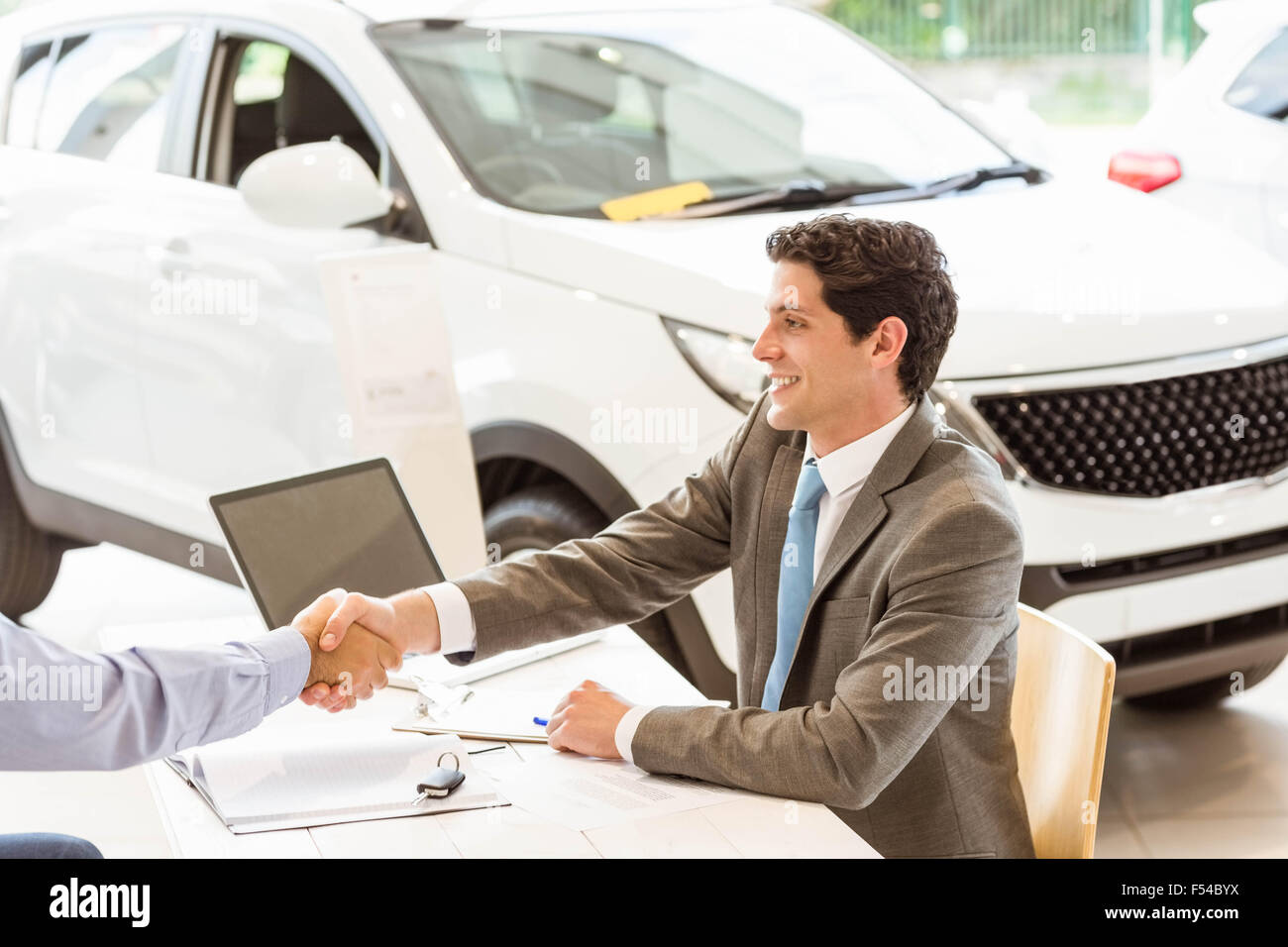 Smiling couple buying a new car Stock Photo