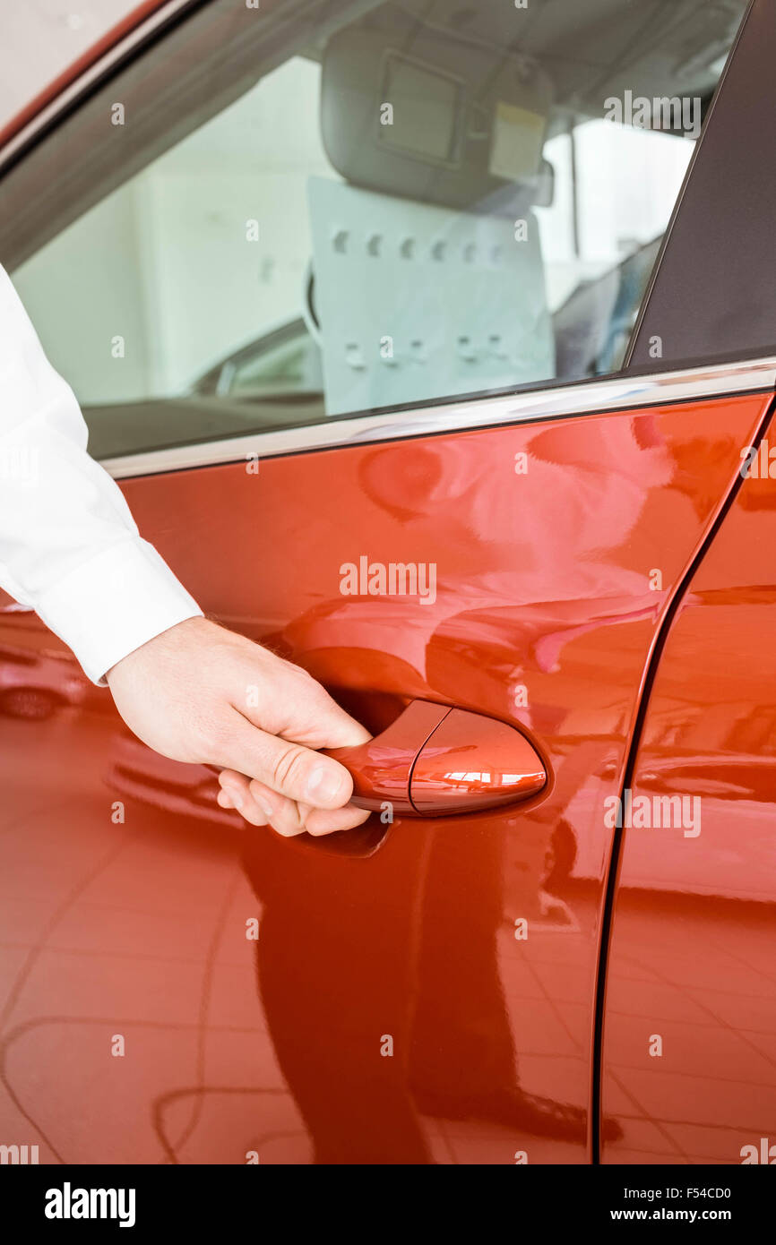 Man holding a car door handles Stock Photo