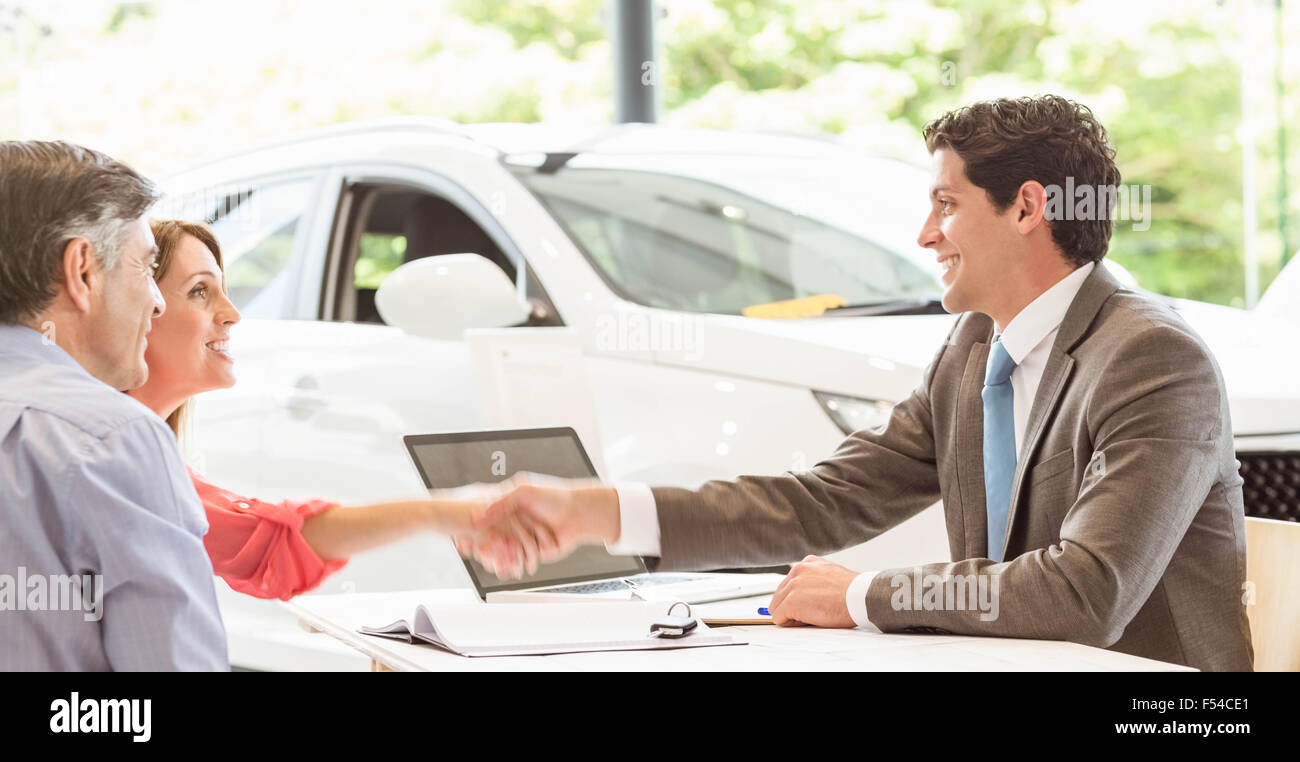 Smiling couple buying a new car Stock Photo