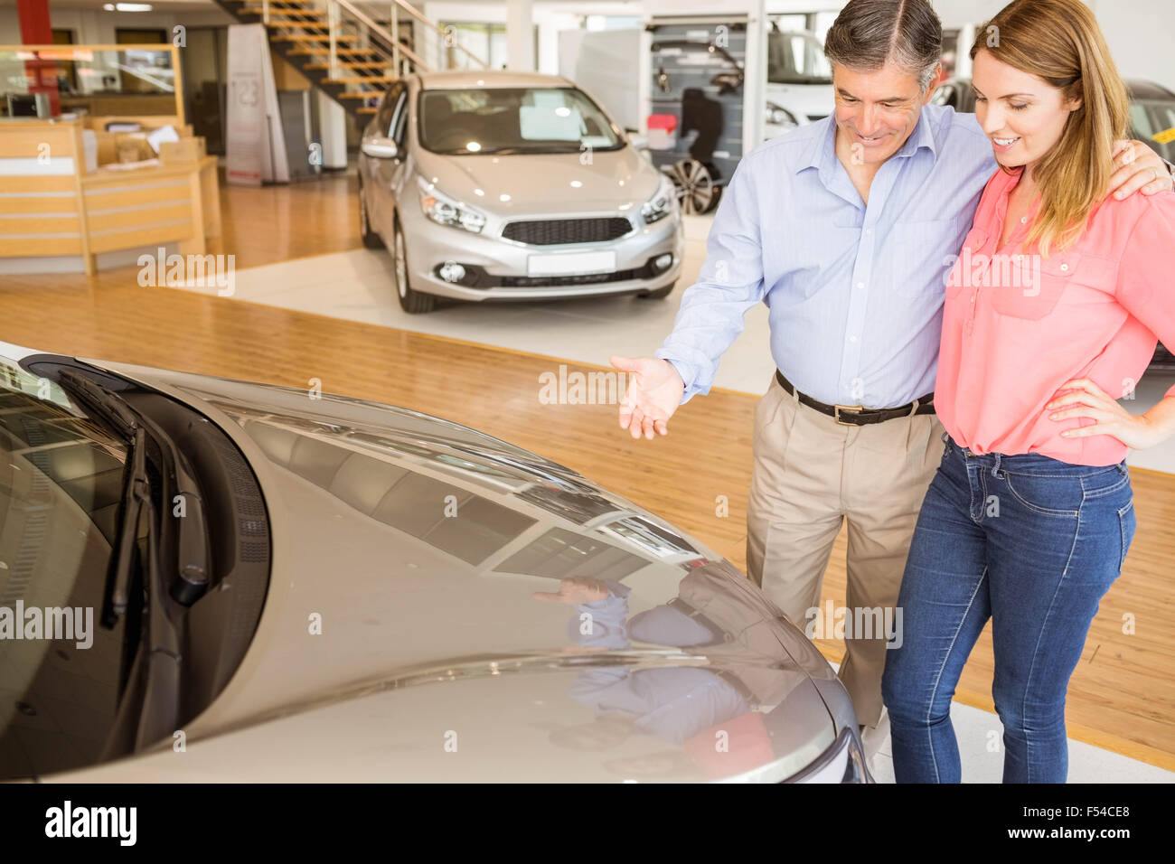 Couple talking together while looking at car Stock Photo