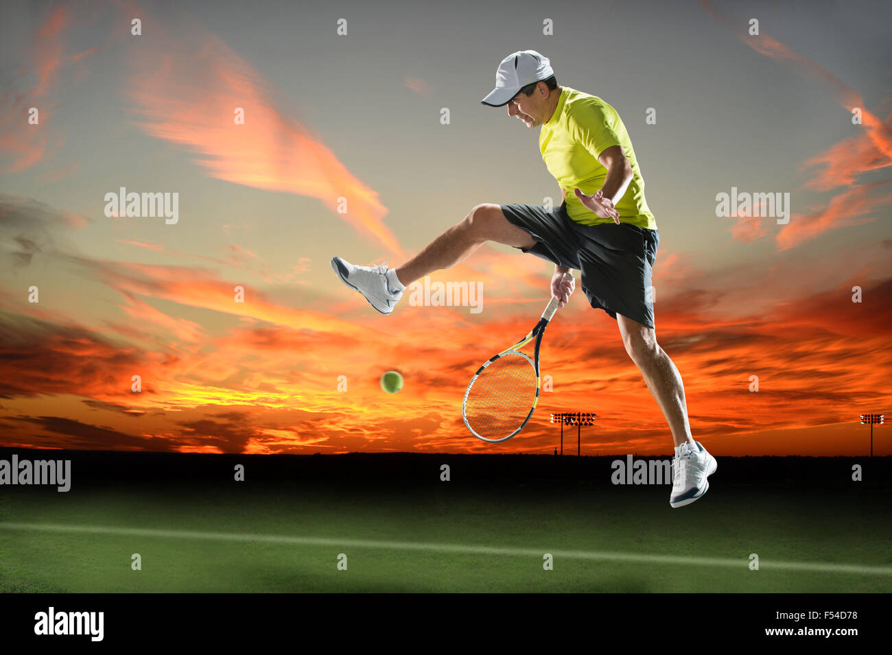 Hispanic tennis player returning ball during sunset Stock Photo Alamy