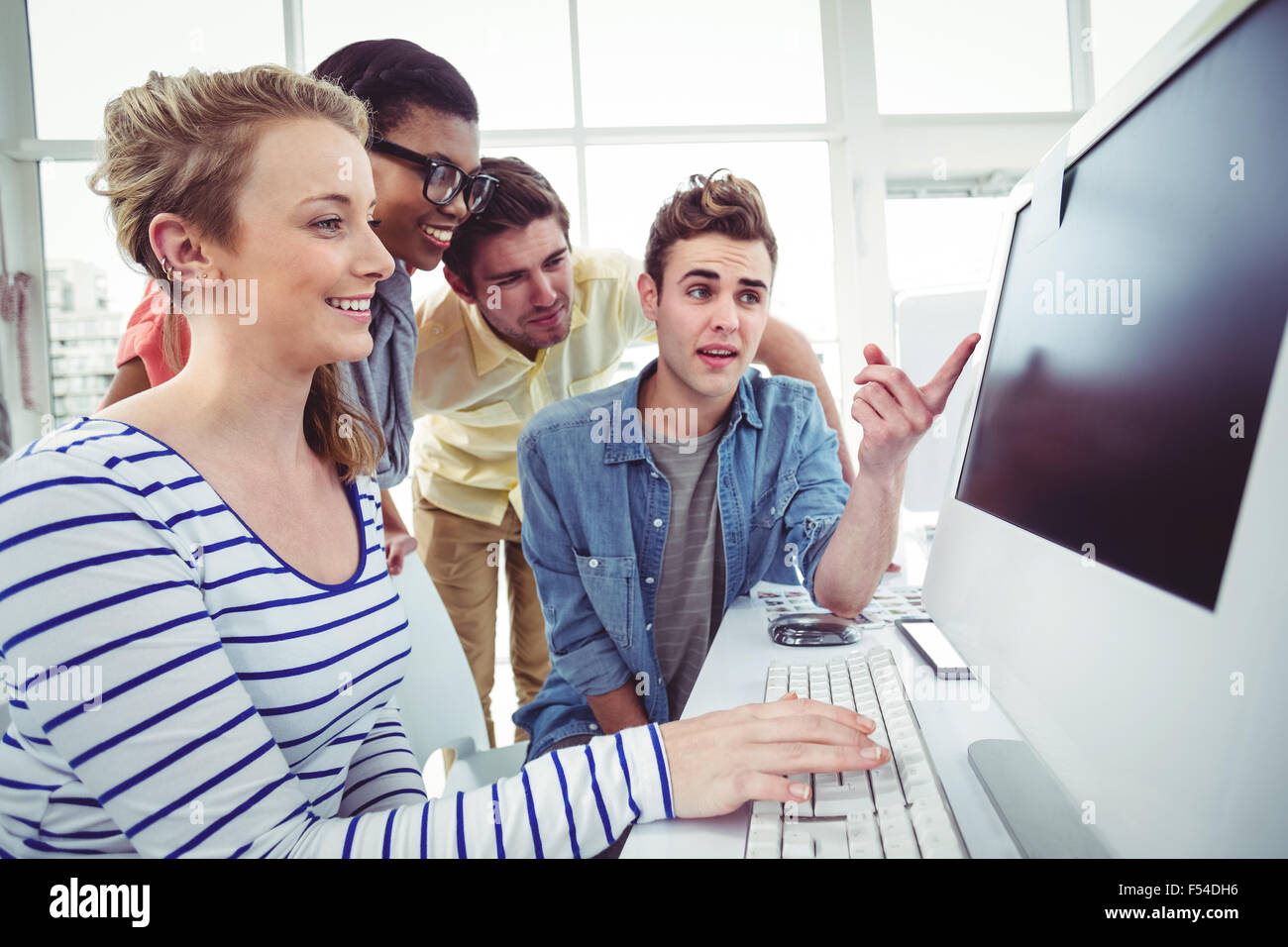 Creative business team working hard together on pc Stock Photo - Alamy