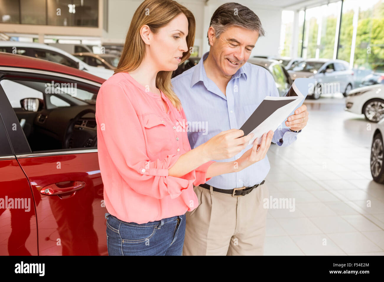 Smiling couple choosing the color of their new car Stock Photo