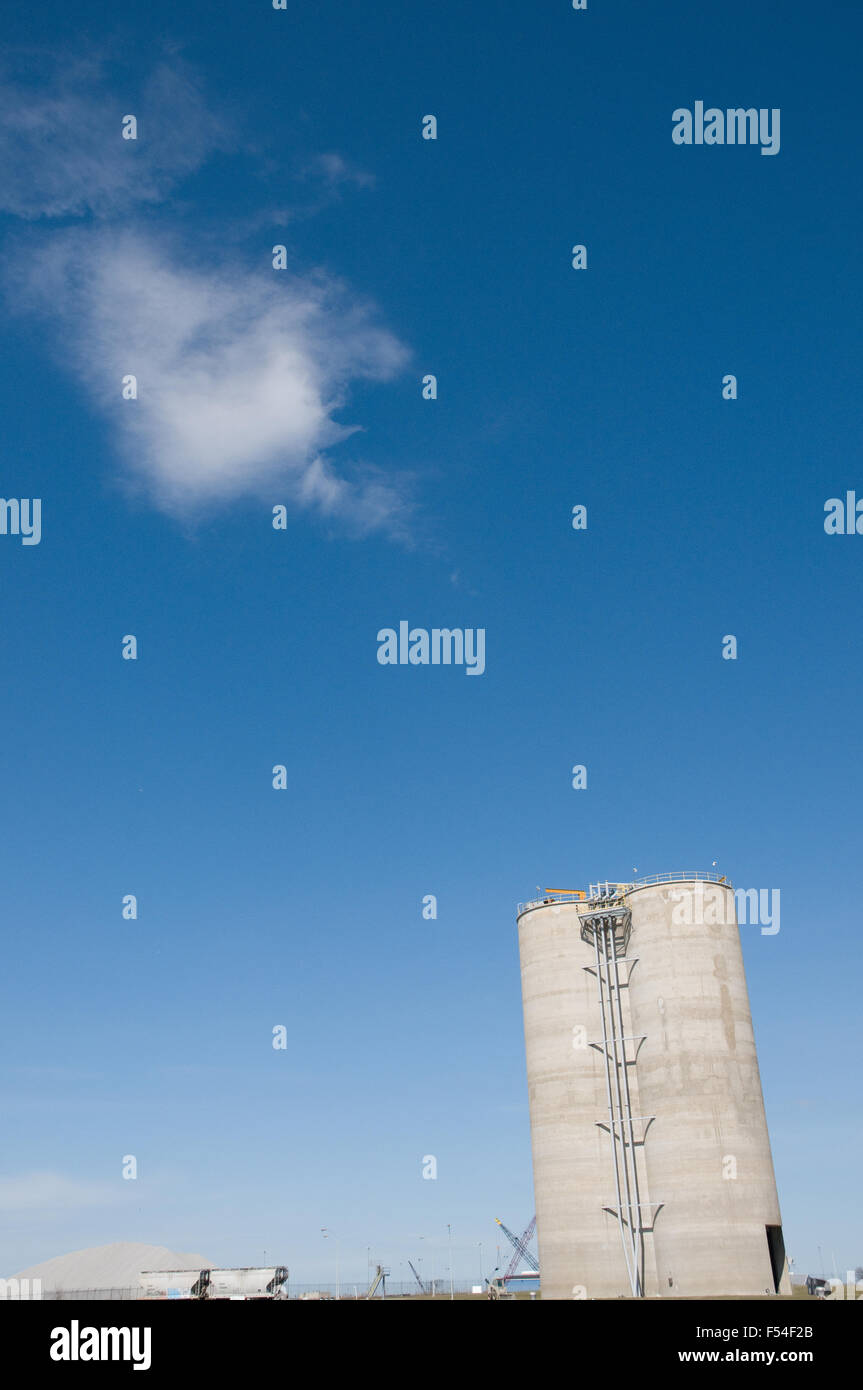 Twin concrete silos with blue sky and white cloud Stock Photo - Alamy