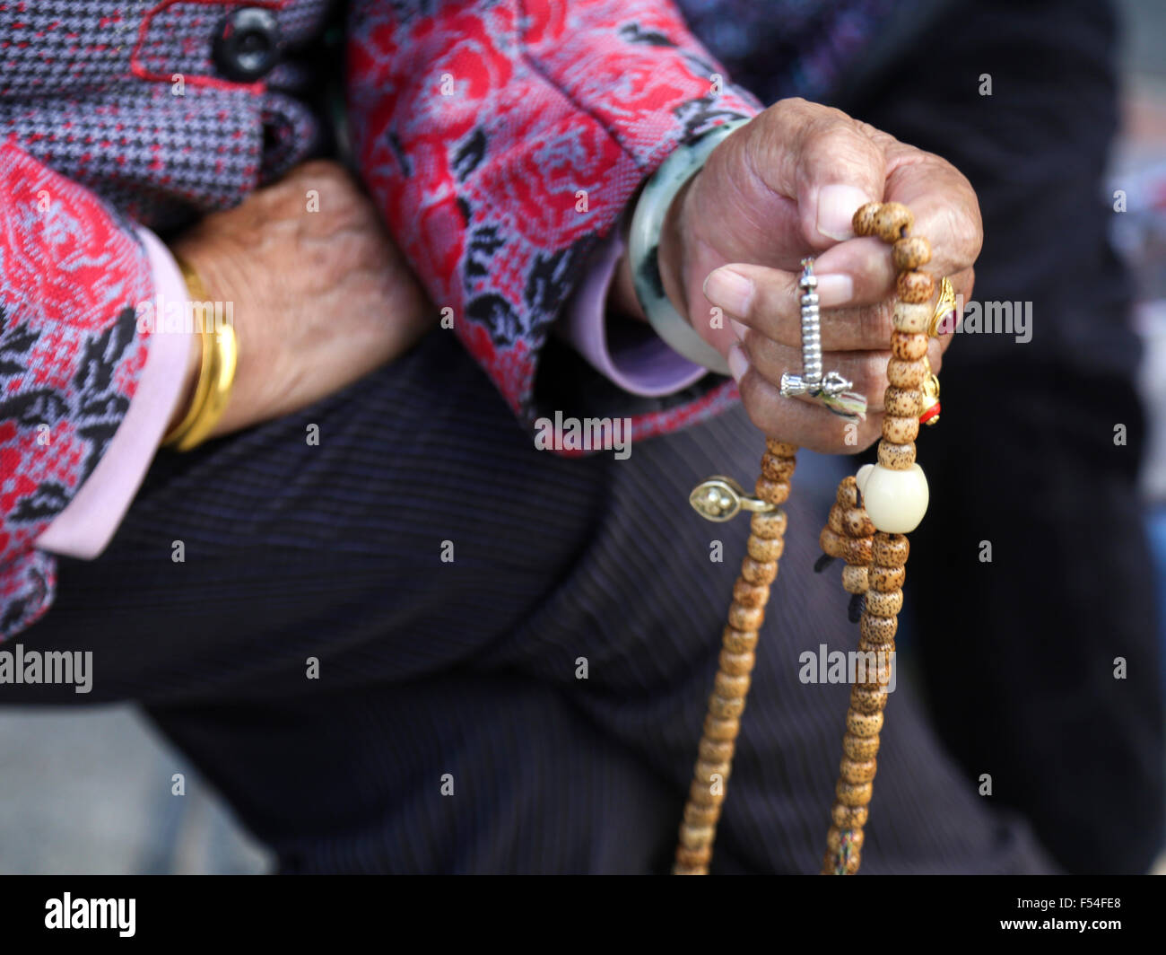 Woman holding a Buddhist prayer chaplet Stock Photo