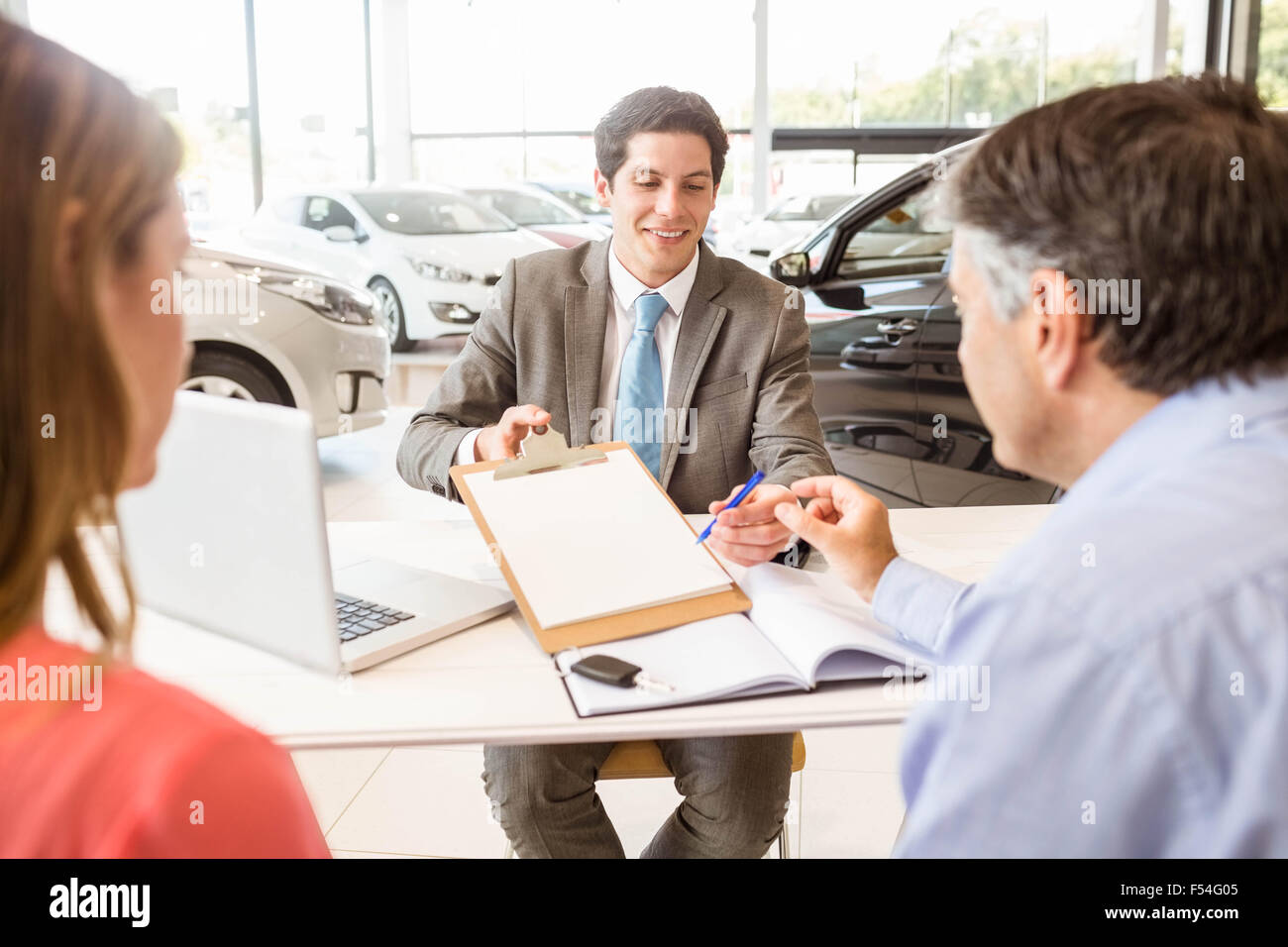 Smiling couple buying a new car Stock Photo