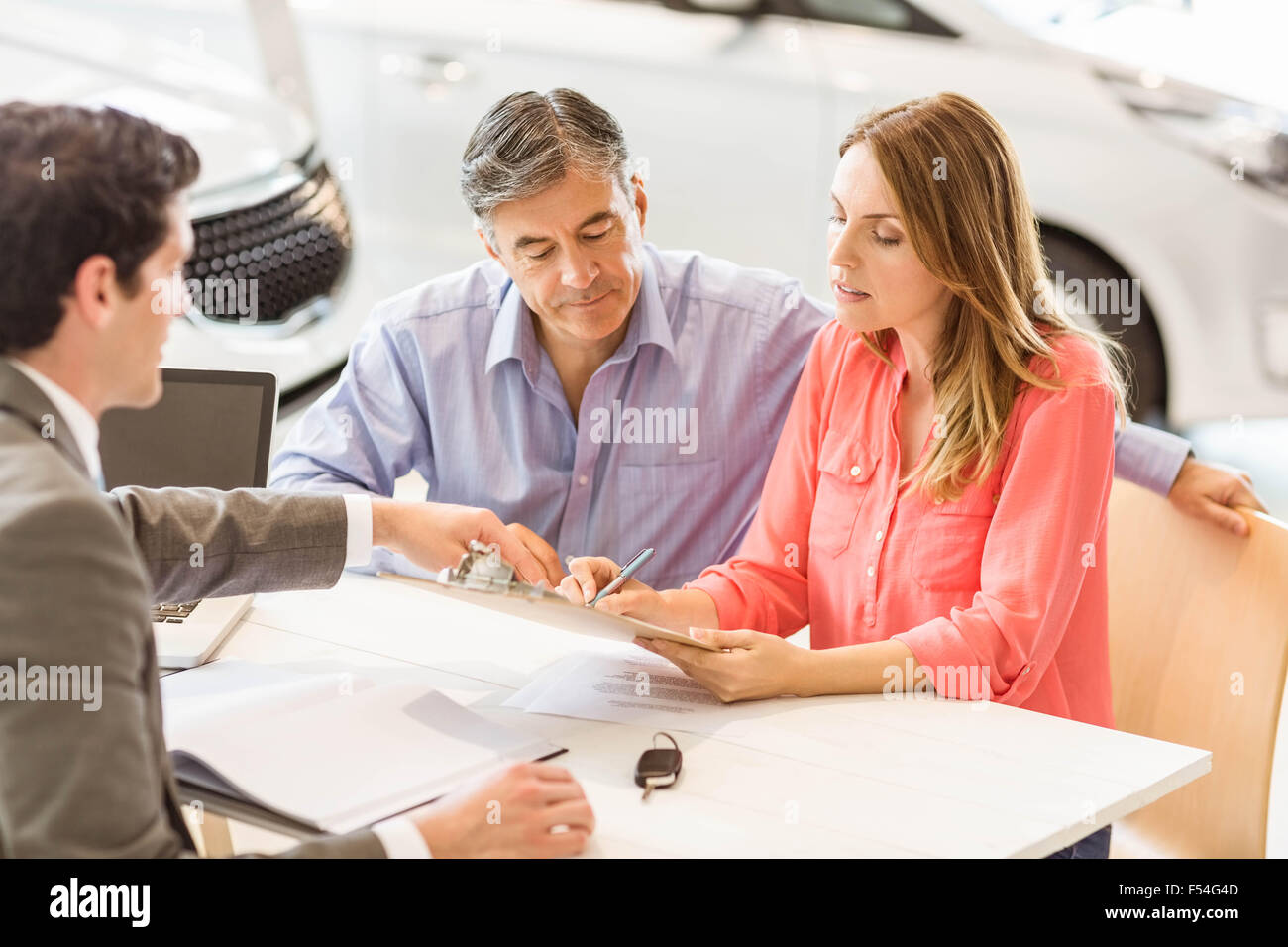 Smiling couple buying a new car Stock Photo