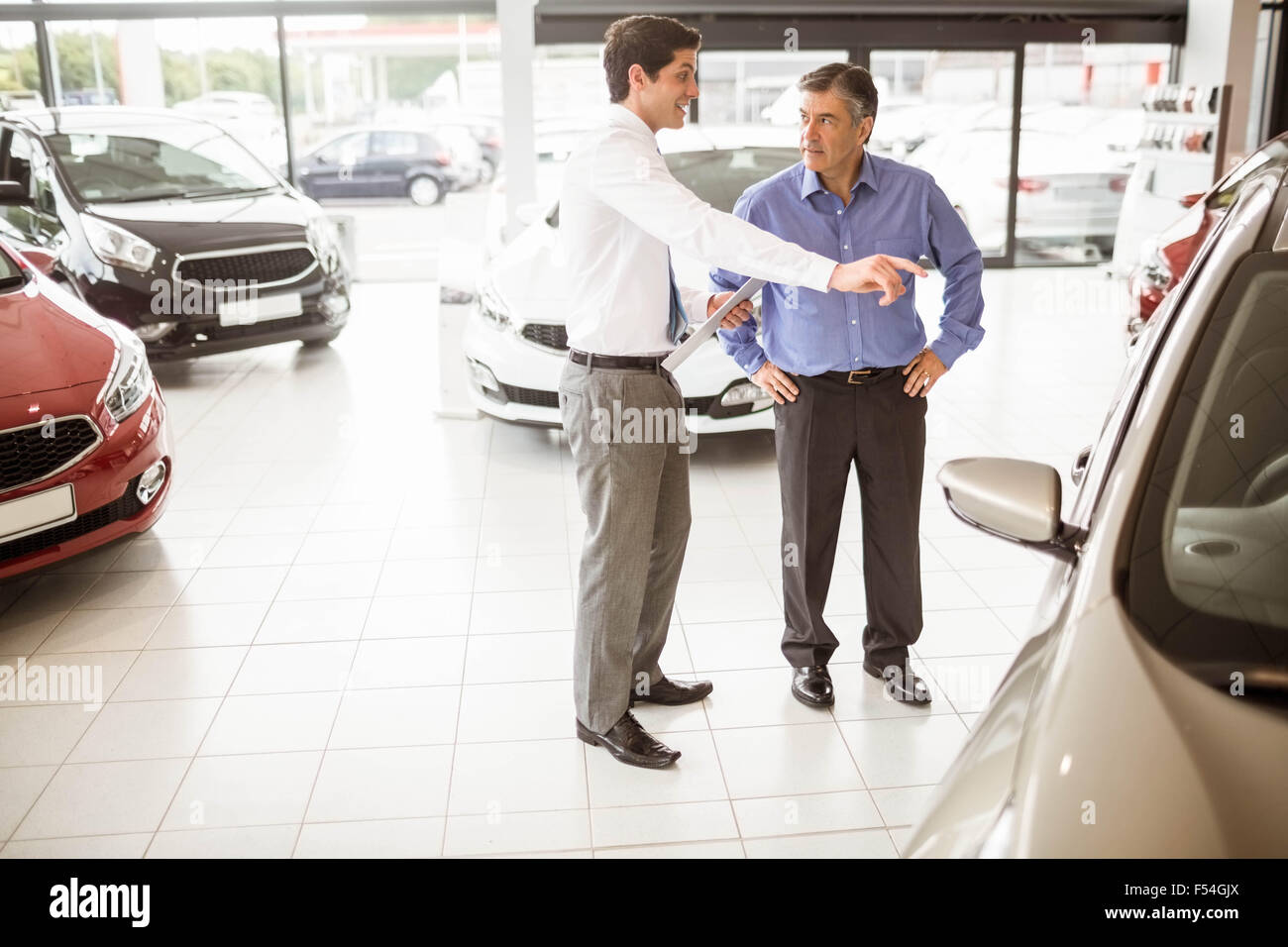 Salesman showing somethings to a man Stock Photo