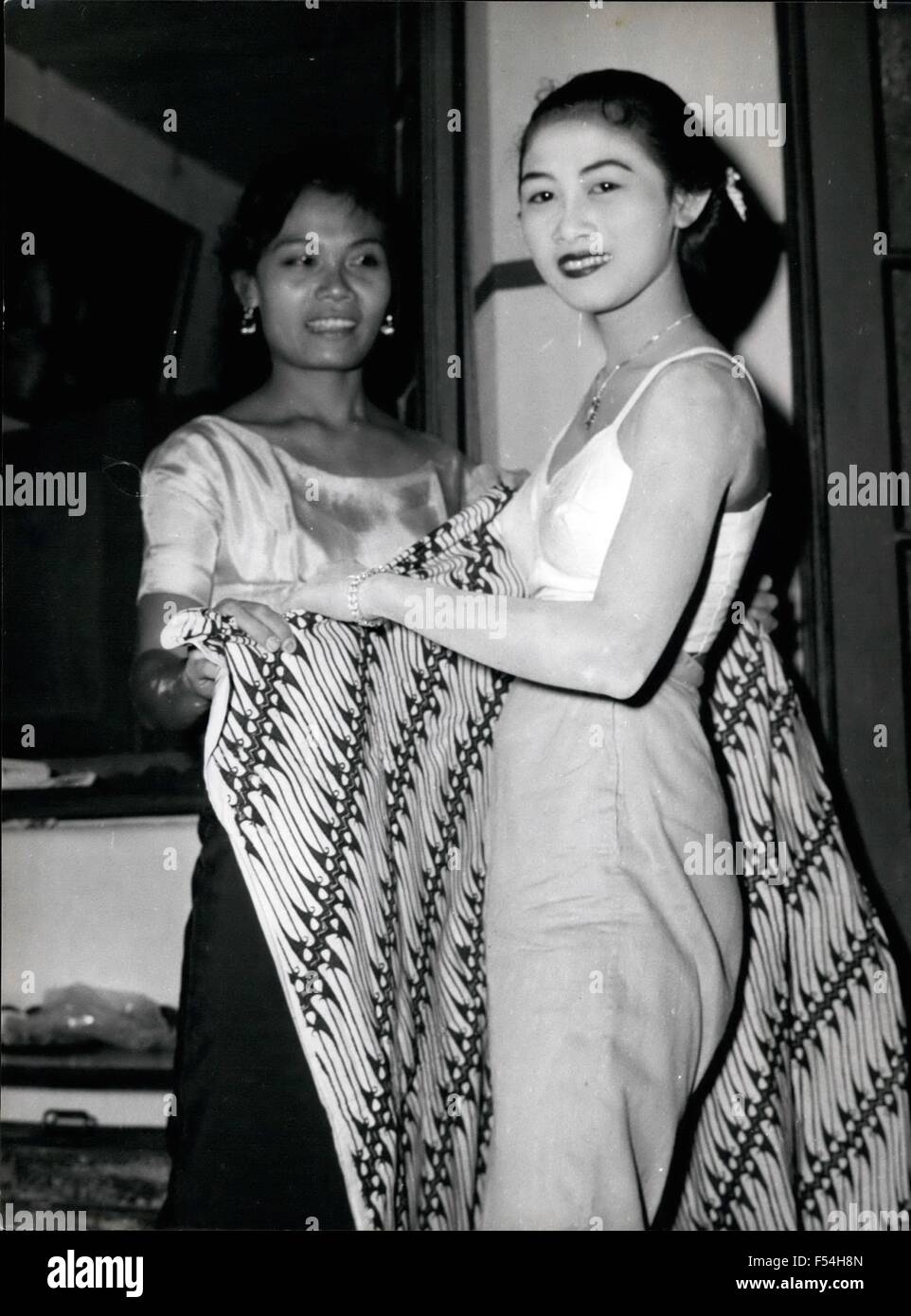 1968 - A Javanese princess dresses for the dance Tomboyish Sri Mulatsih is helped into a traditional hand-dyed solo sarong by Sri Hartinah. She keeps her Weston - style jeans underneath. (Credit Image: © Keystone Pictures USA/ZUMAPRESS.com) Stock Photo