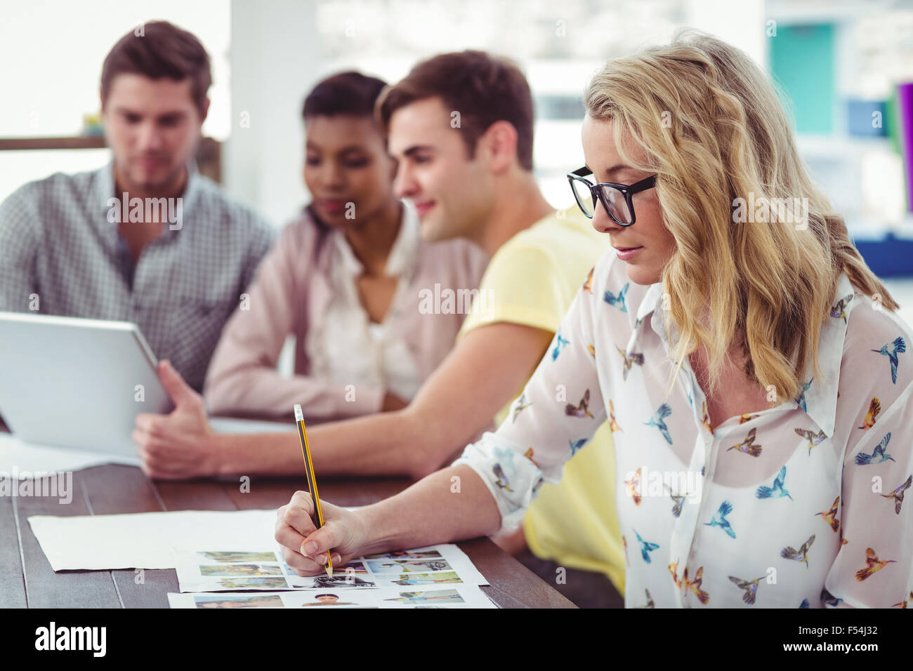 Creative business team working on a laptop together Stock Photo - Alamy
