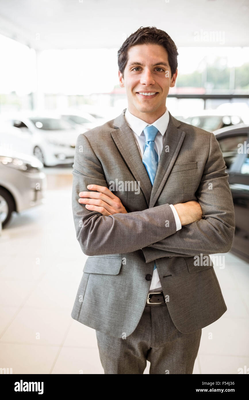 Smiling businessman standing with arms crossed Stock Photo - Alamy