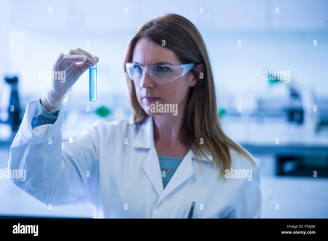 Scientist looking at test tube in the laboratory Stock Photo - Alamy