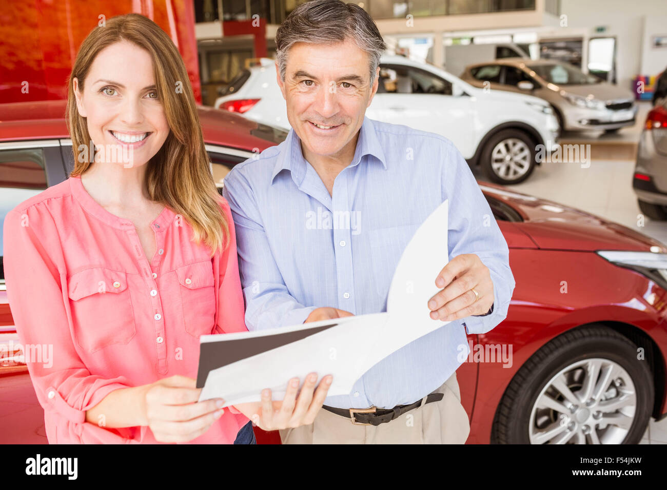 Smiling couple choosing the color of their new car Stock Photo