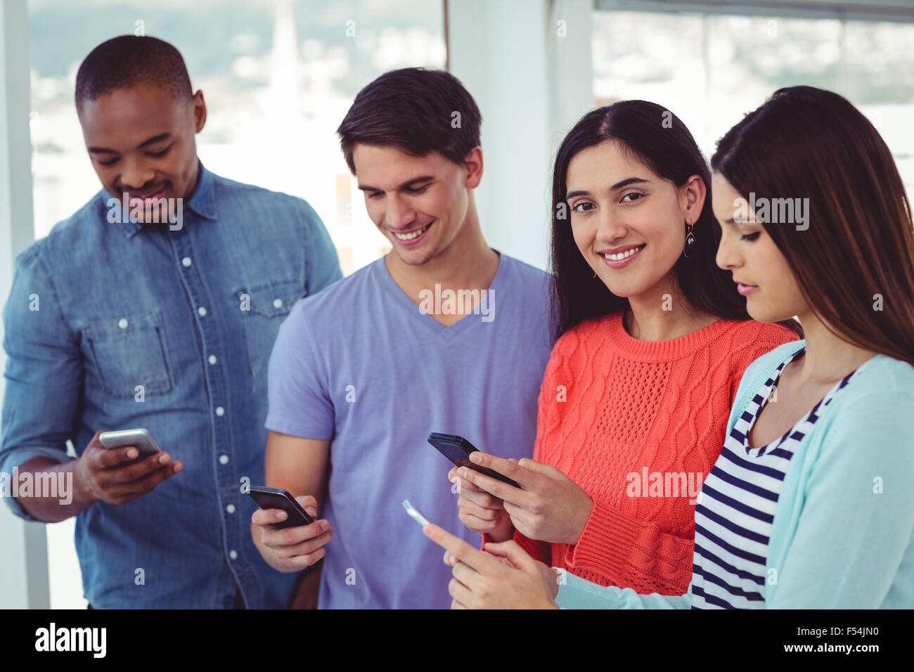 All looking at phones hi-res stock photography and images - Alamy