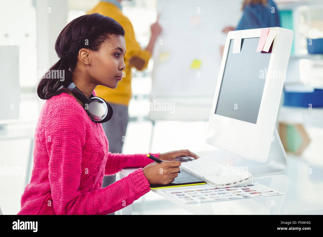 Creative businesswoman wearing headphones at her desk Stock Photo - Alamy