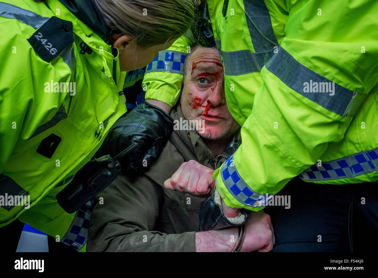Newcastle, UK, UK. 28th Feb, 2015. Police help an injured and bloody man as more than 1,500 protesters demonstrated against the first rally in Britain by a group opposed to what it calls the ''Islamisation of Europe''. Supporters of the UK branch of German group Pegida (Patriotic Europeans Against the Islamization of the West) gathered at Newcastle city centre's Bigg Market. A counter-rally took place in Newgate Street, within sight of about 400 Pegida UK demonstrators. Northumbria Police, which had a cordon separating the two camps, said four arrests had been made after isol Stock Photo