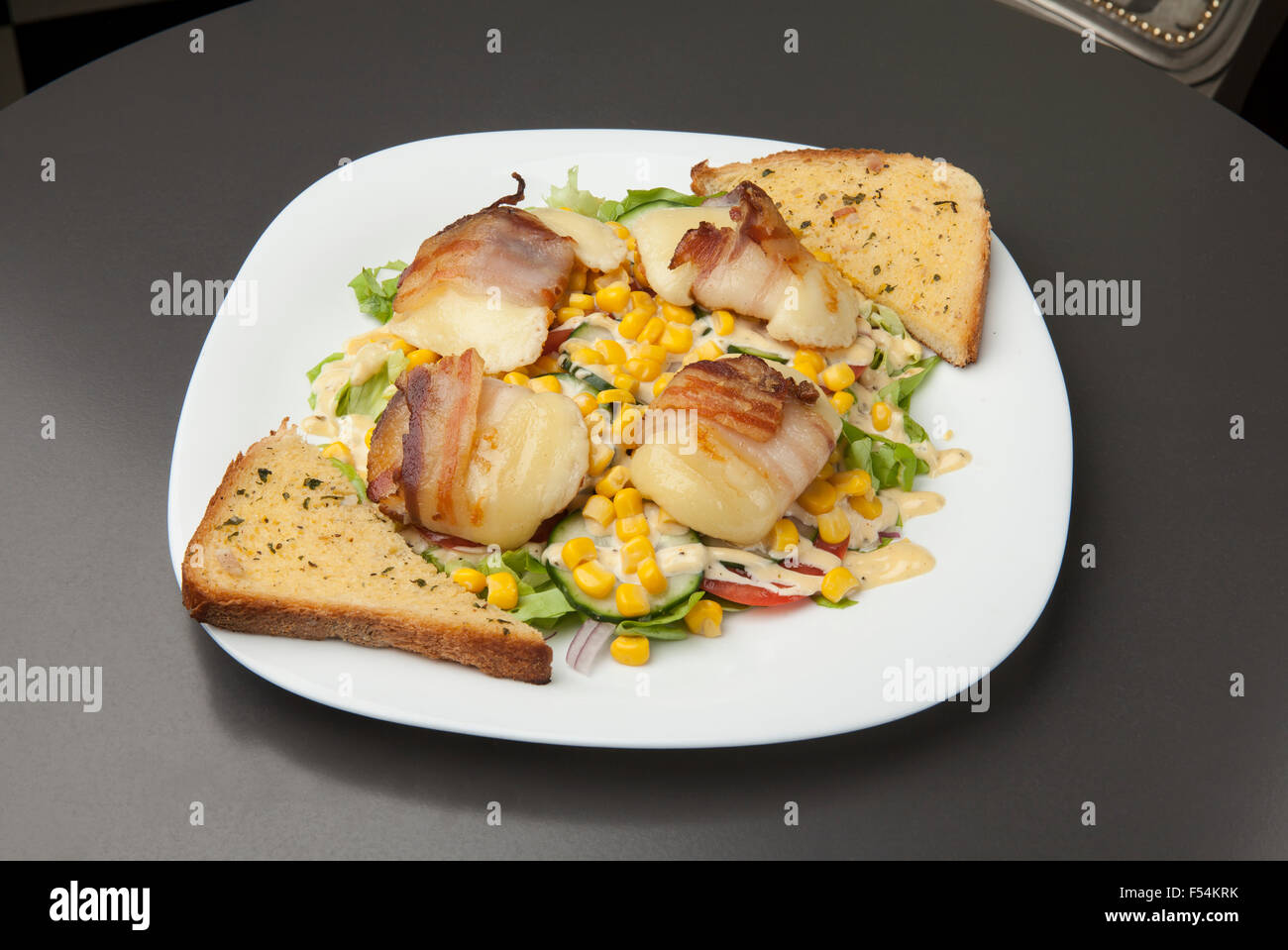 grilled bacon with a side dish of vegetables and cheese Stock Photo