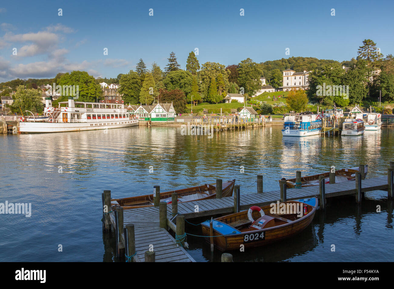 Bowness-on-Windermere, United Kingdom - September 7, 2015: Afternoon photo of Bowness-on-Windermere harbor with wooden boats and Stock Photo