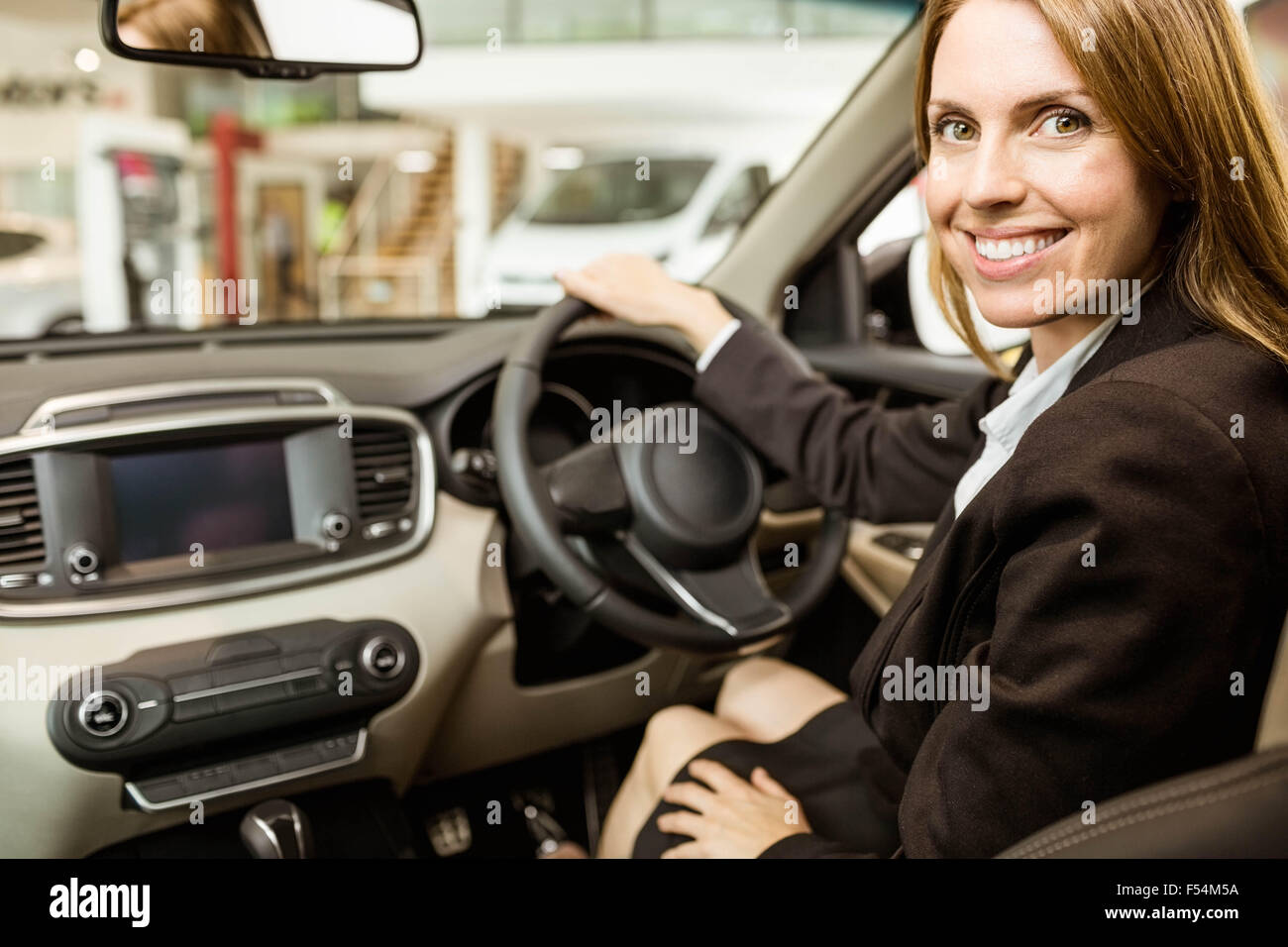 Smiling businesswoman siting in a car Stock Photo