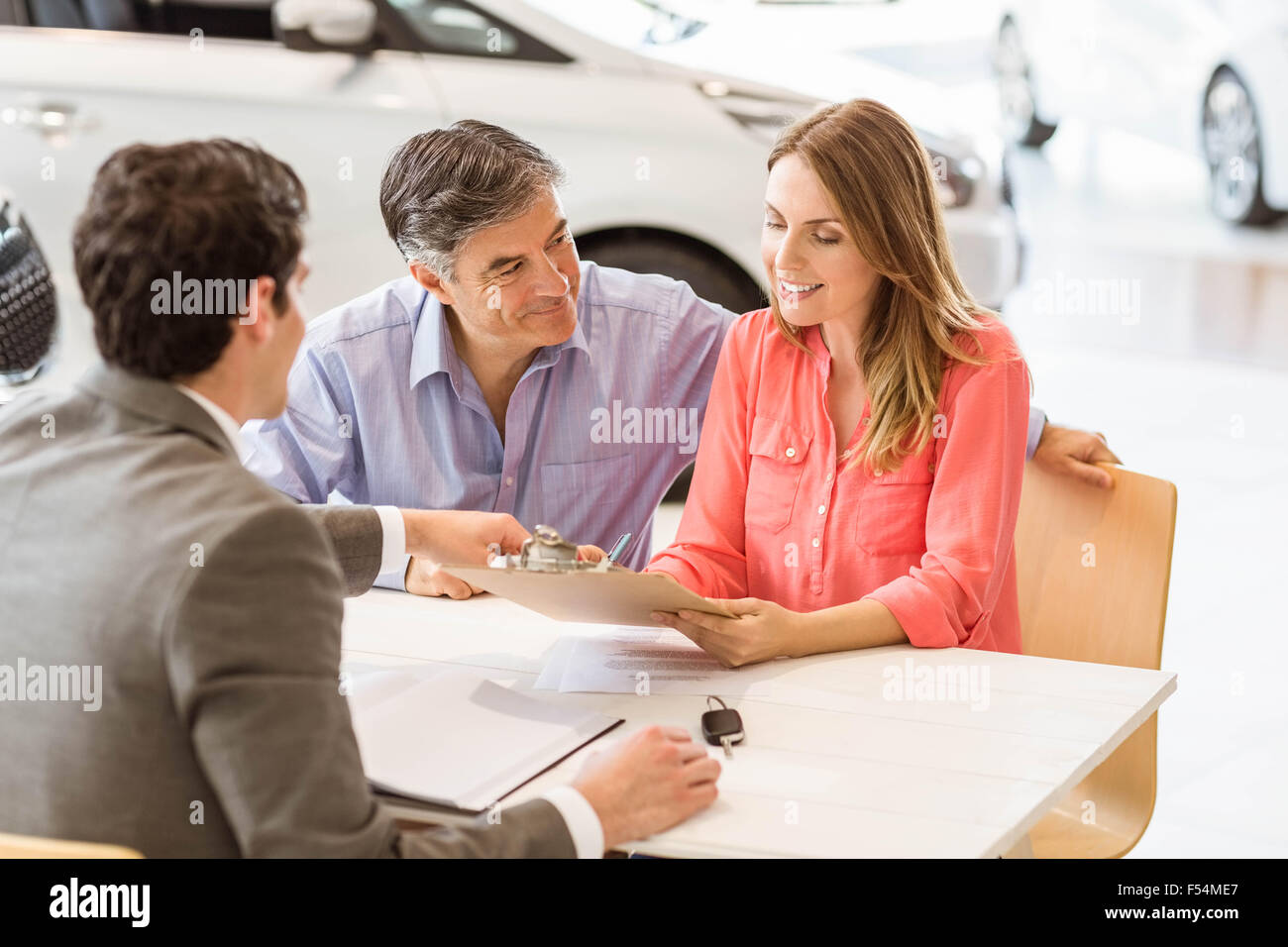 Smiling couple buying a new car Stock Photo